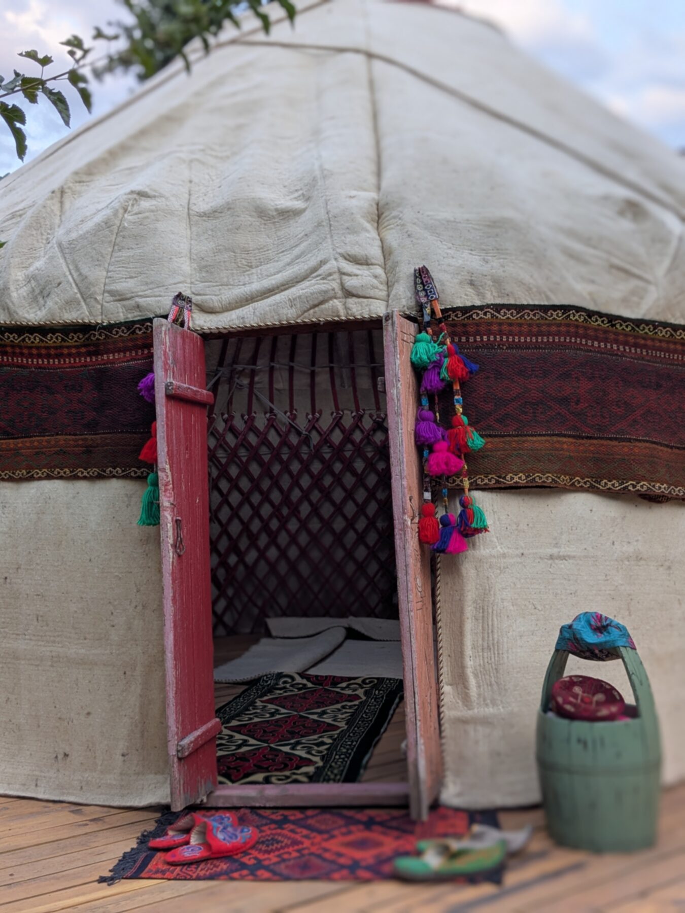 Yurt entrance — carved door, colourful tassels