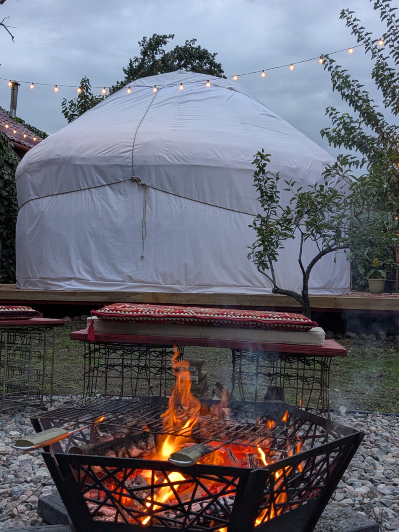 Fire pit at dusk with kilim seating