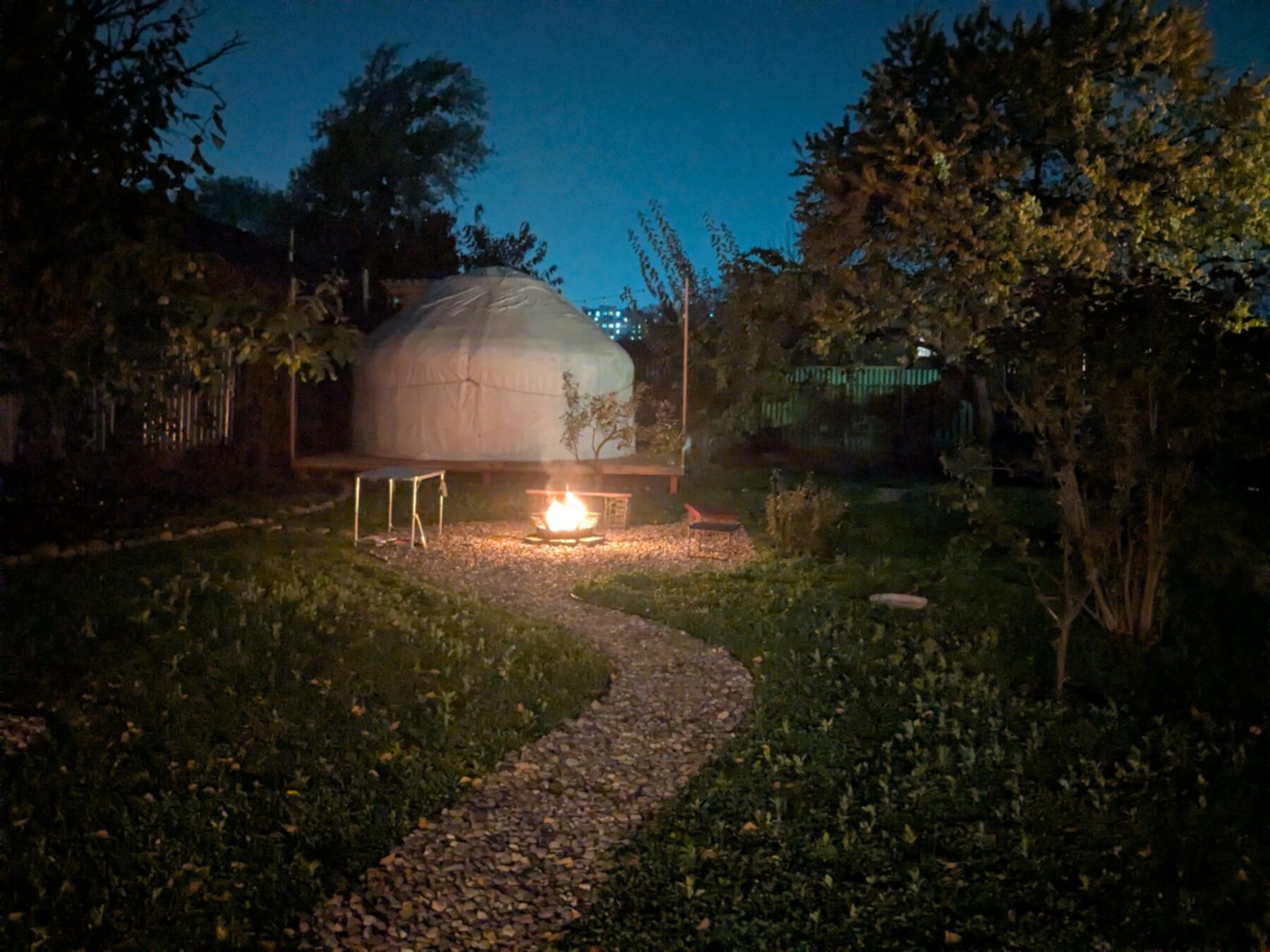 Yurt39 at night — fire glowing, string lights