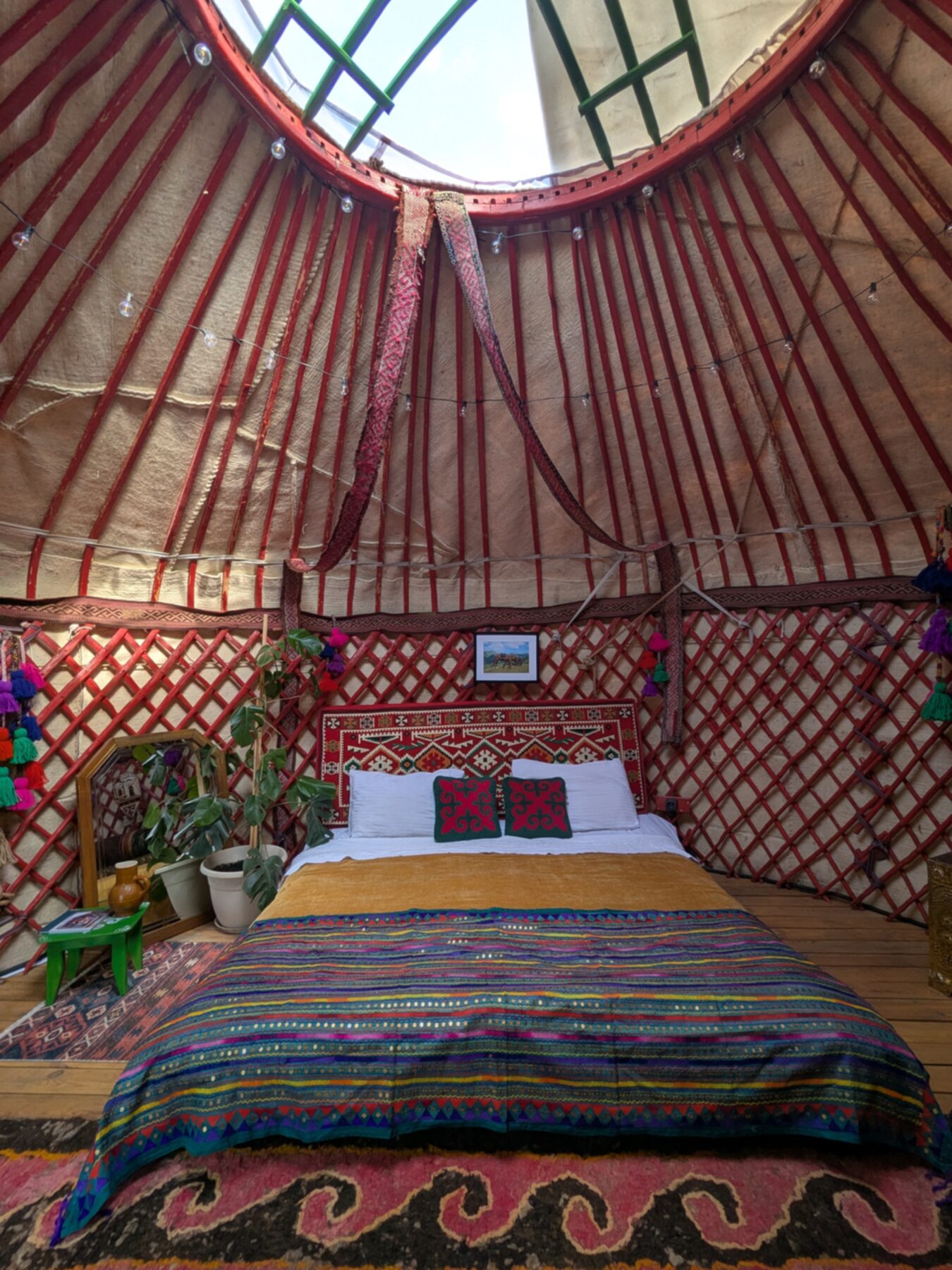 Yurt39 interior — crown wheel, kilims, warm light
