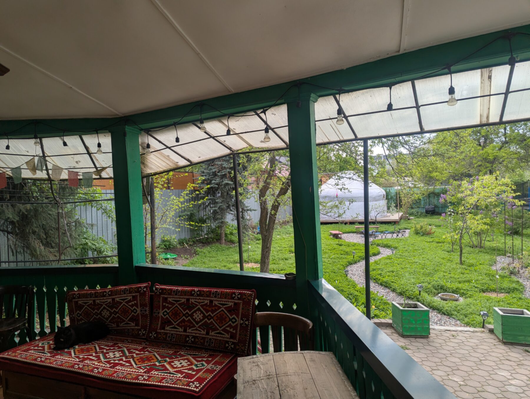 House veranda — kilim bench, view to garden