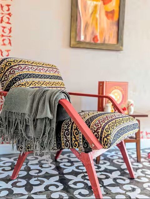 Kazakh-pattern armchair on painted tile floor