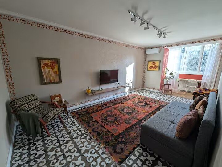 Pater25 living room — kilim rug, Kazakh stencil border